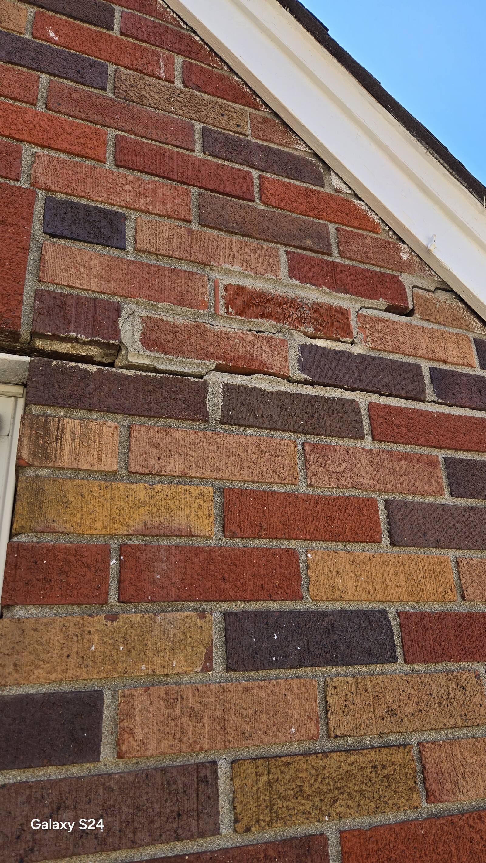 Damaged brick being cut out and replaced on an Omaha home