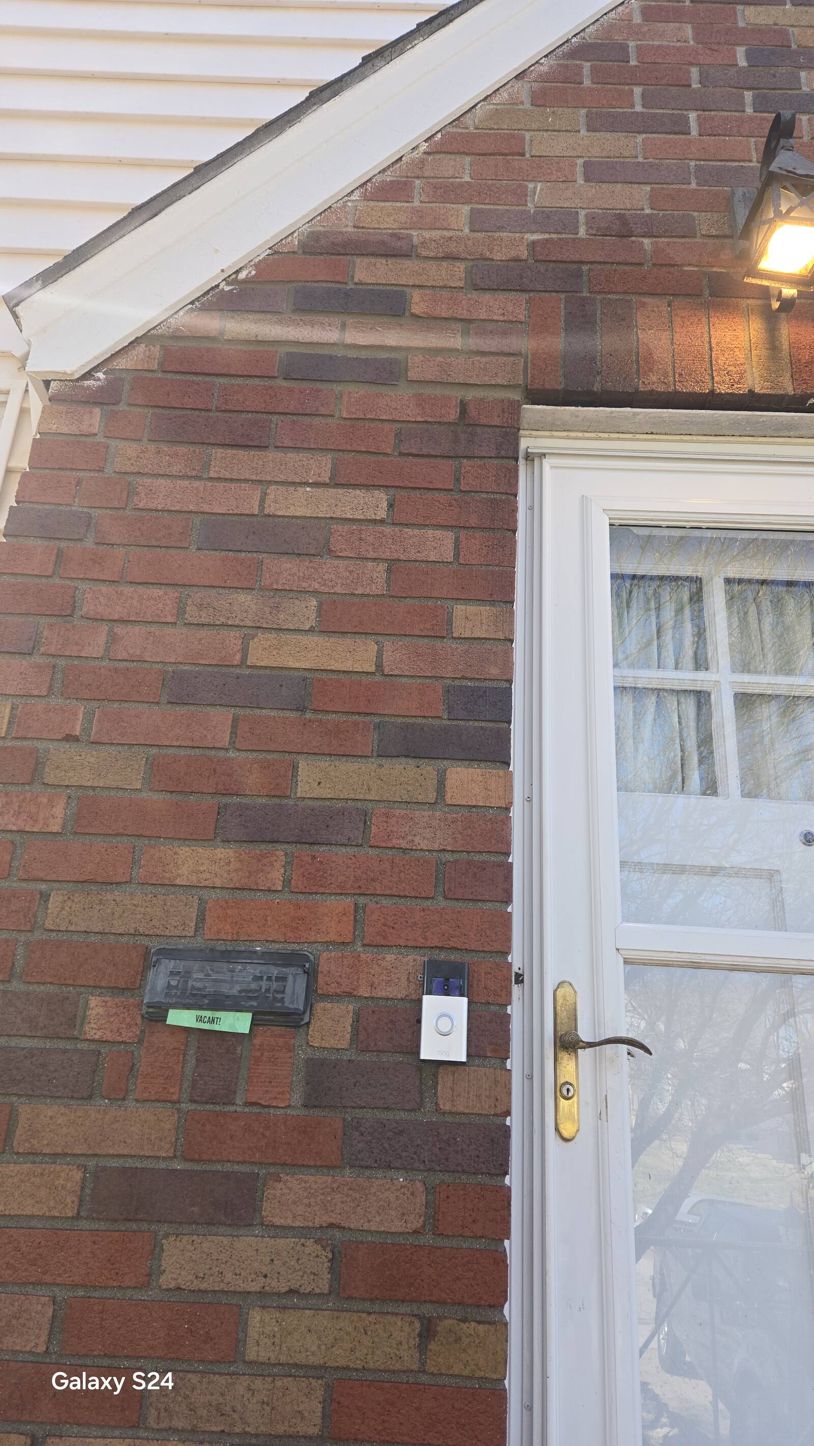 Matched multicolor brick repair at a home entry