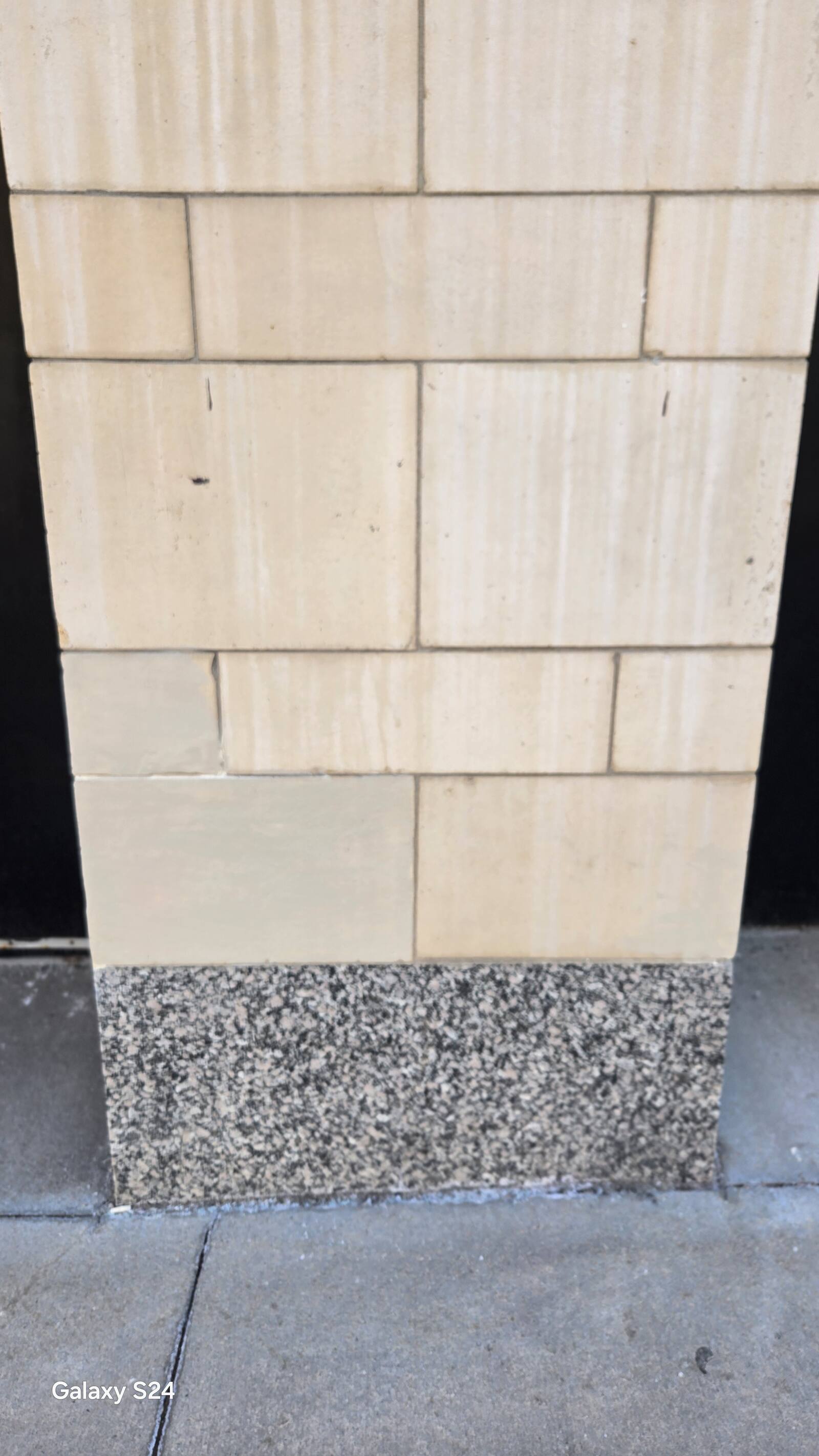 Limestone column and granite base on a commercial building
