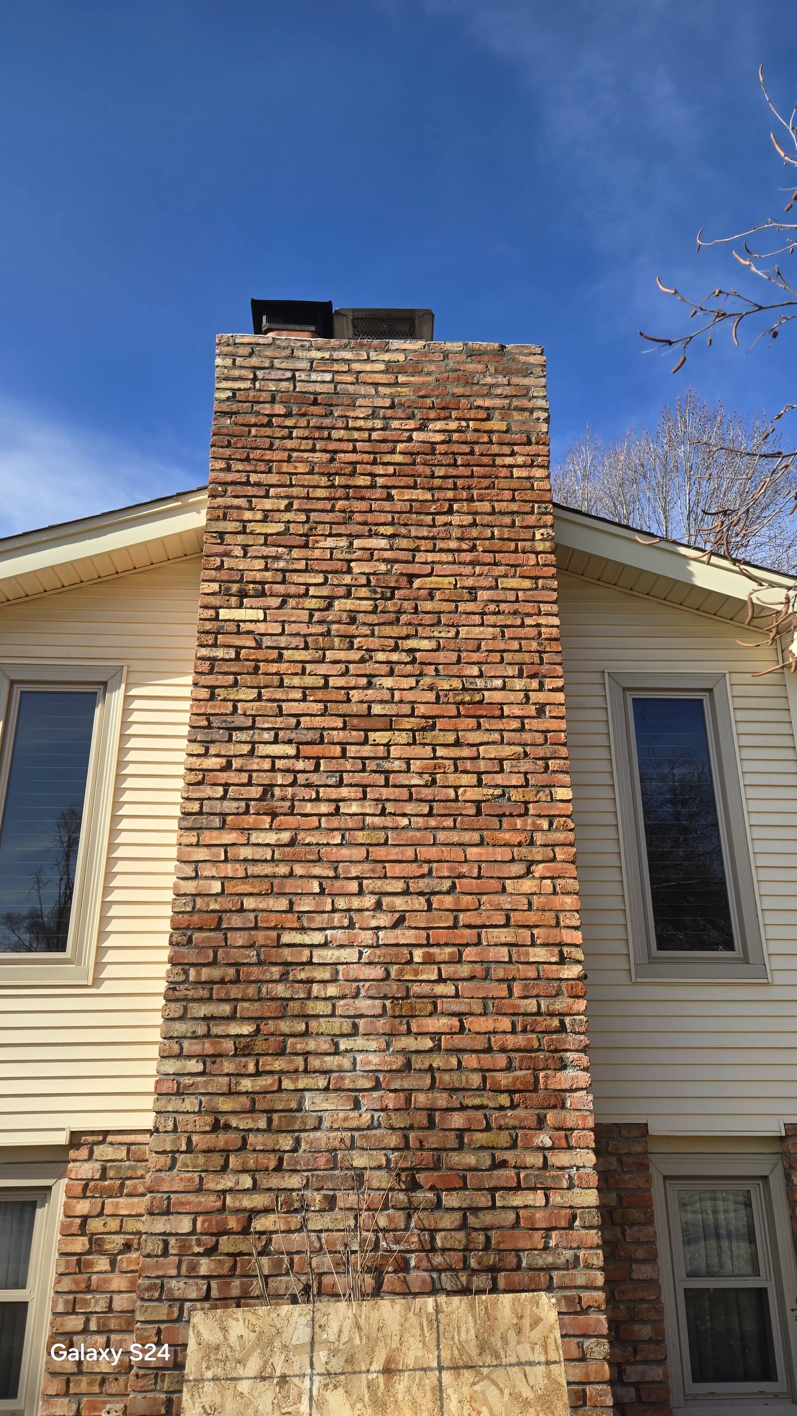 Tall restored brick chimney on an older Omaha home
