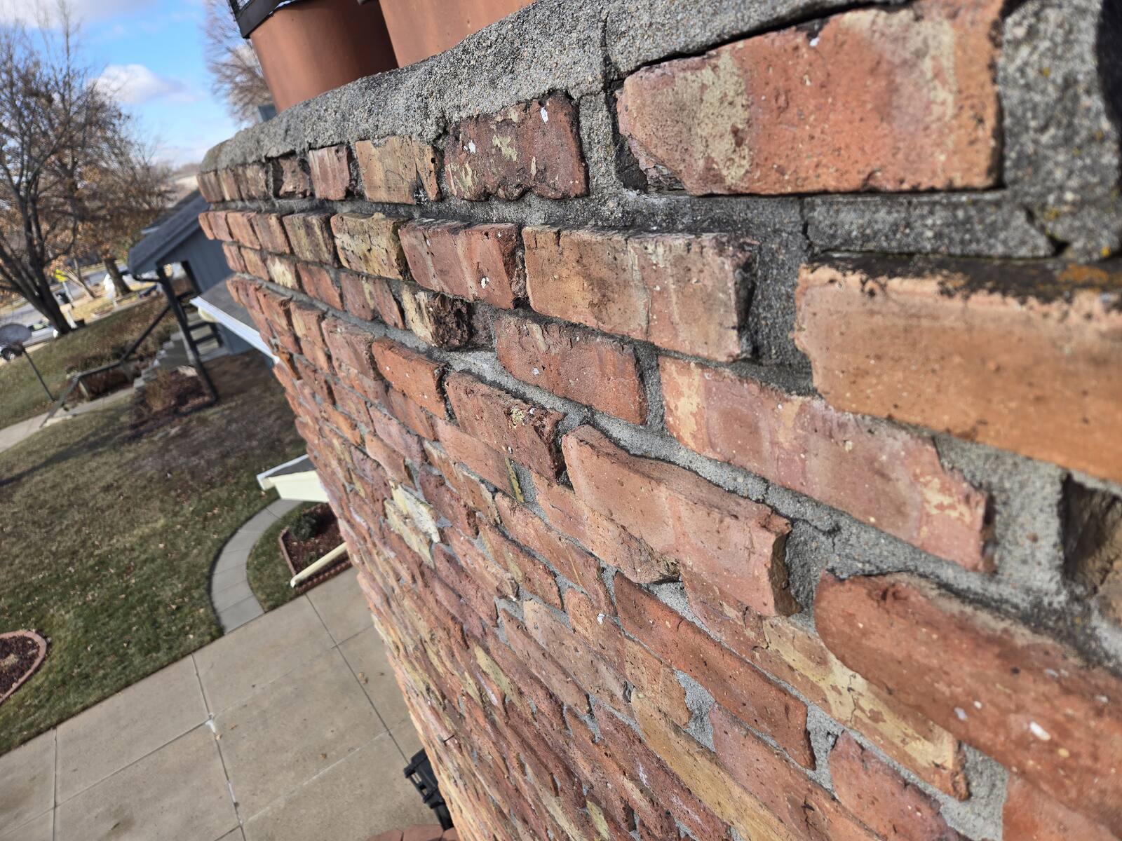 Failing stone and brick facade being repaired by Omaha Masonry