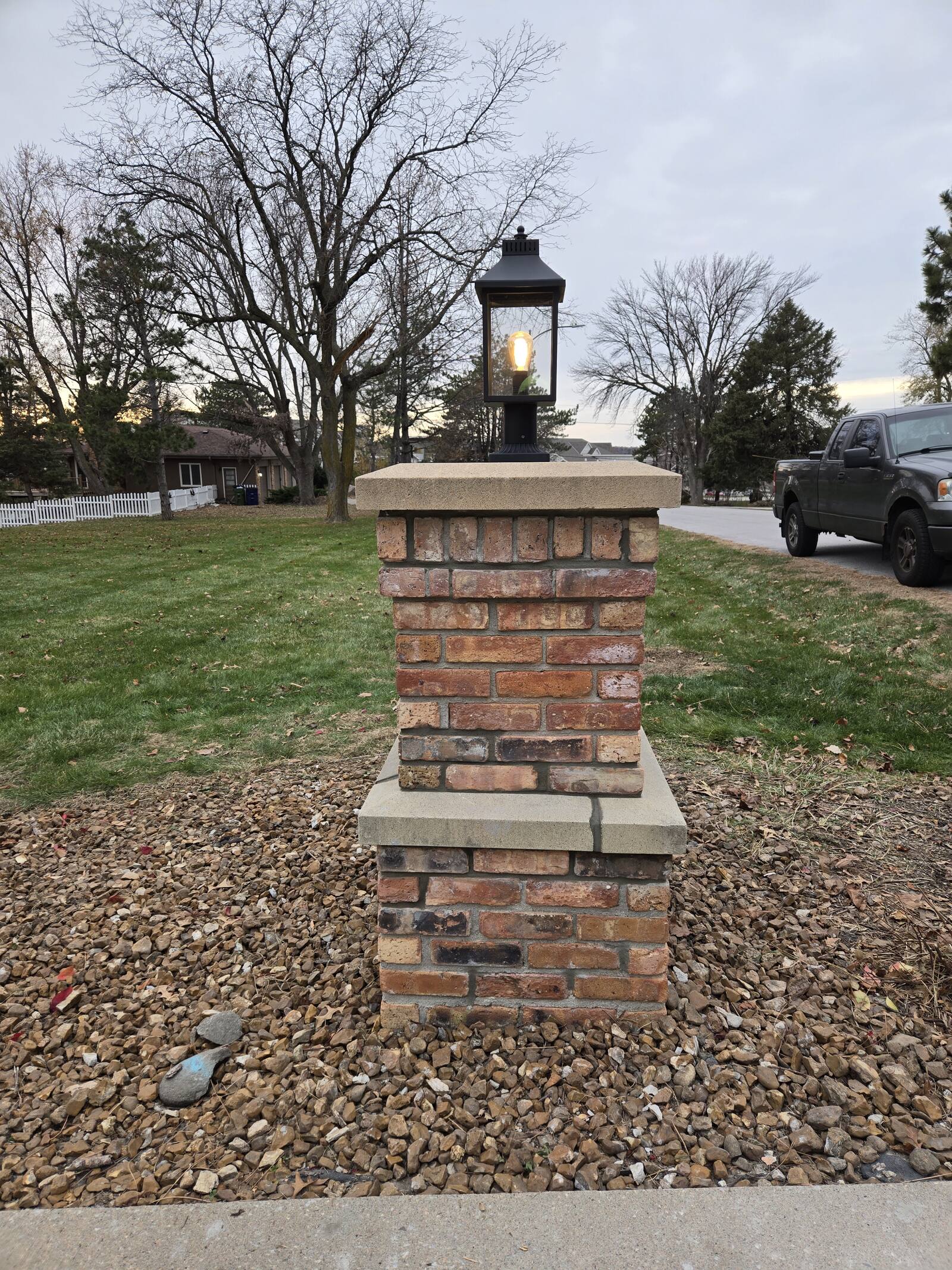 Restored brick lamp pillar in a mature Omaha neighborhood