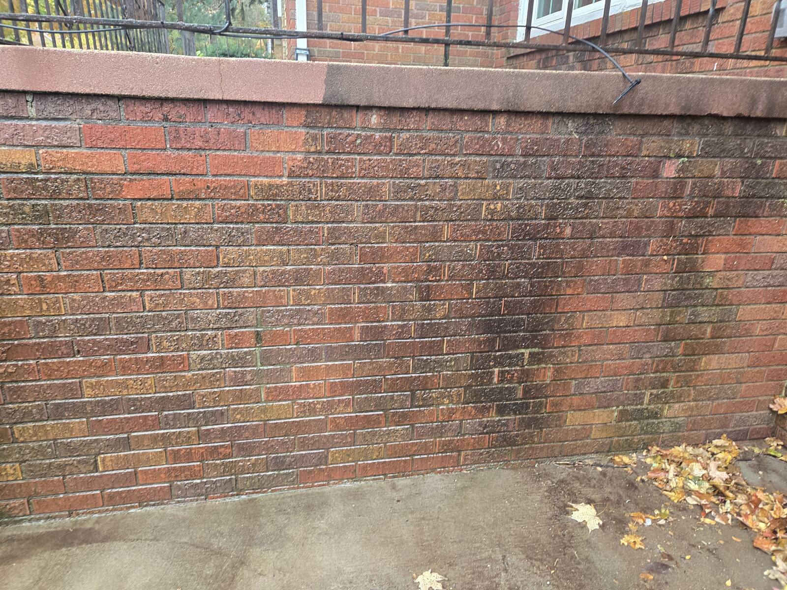 Long brick retaining wall with concrete cap